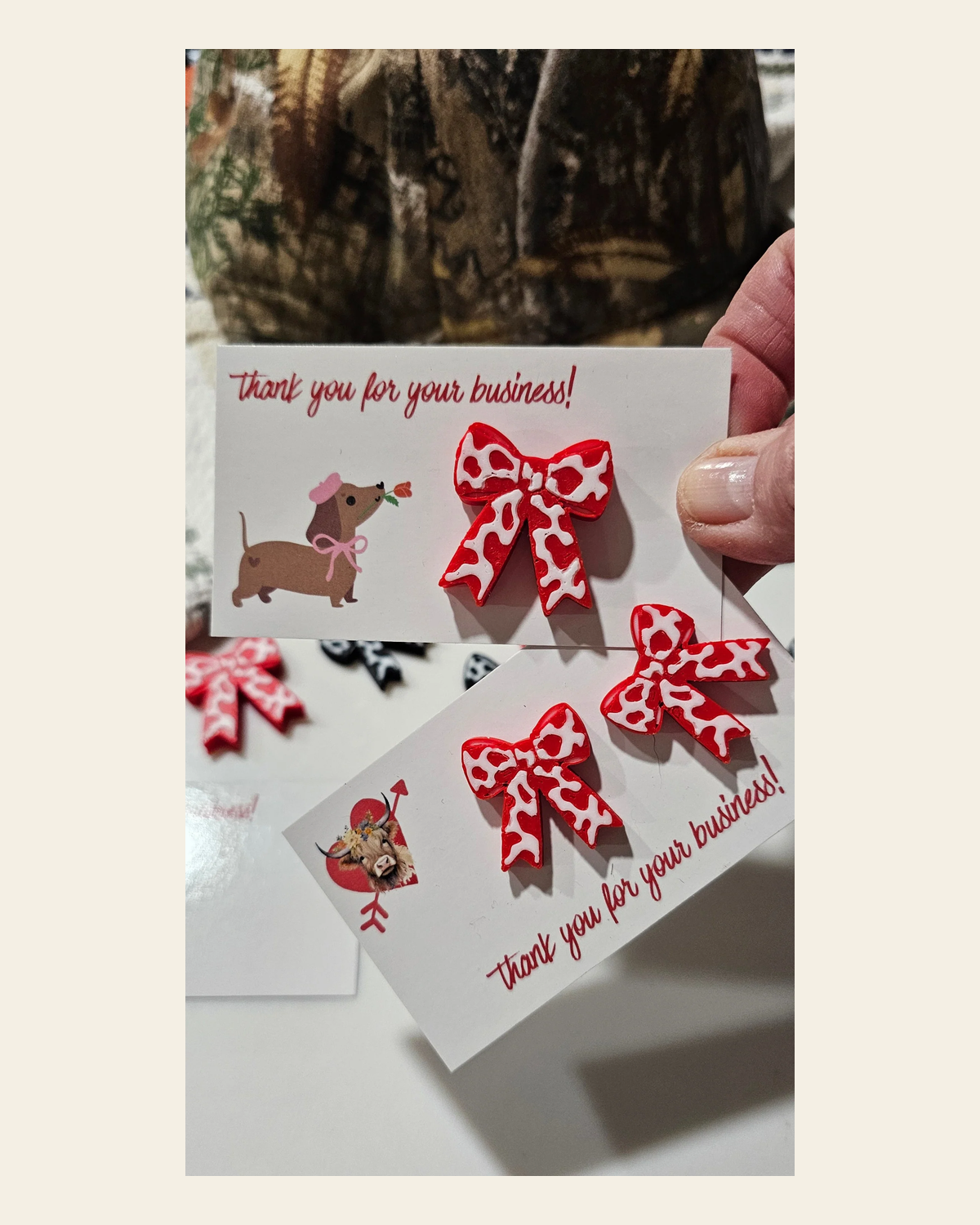Bag of 25 -Boutique 3d Printed Package Inserts Cow Print Bows Pins or Earrings Made in America on a warm cream background