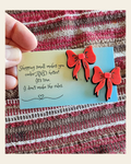 Bag of 25 -Boutique 3d Printed Package Inserts Red Bow Earrings Made in America on a warm cream background