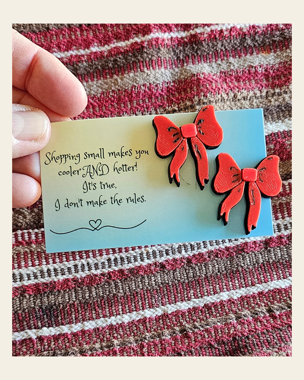 Bag of 25 -Boutique 3d Printed Package Inserts Red Bow Earrings Made in America on a warm cream background