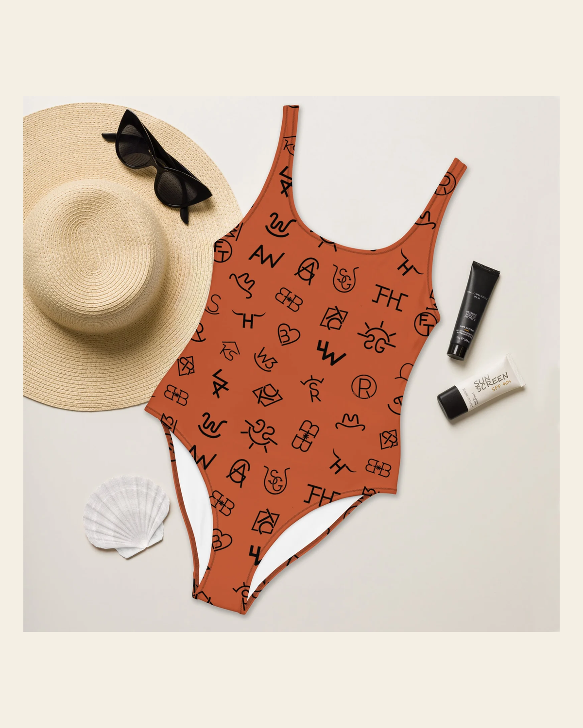 Baha Ranch Yeehaw Brown Cattle Brands One-Piece Swimsuit on a warm cream background
