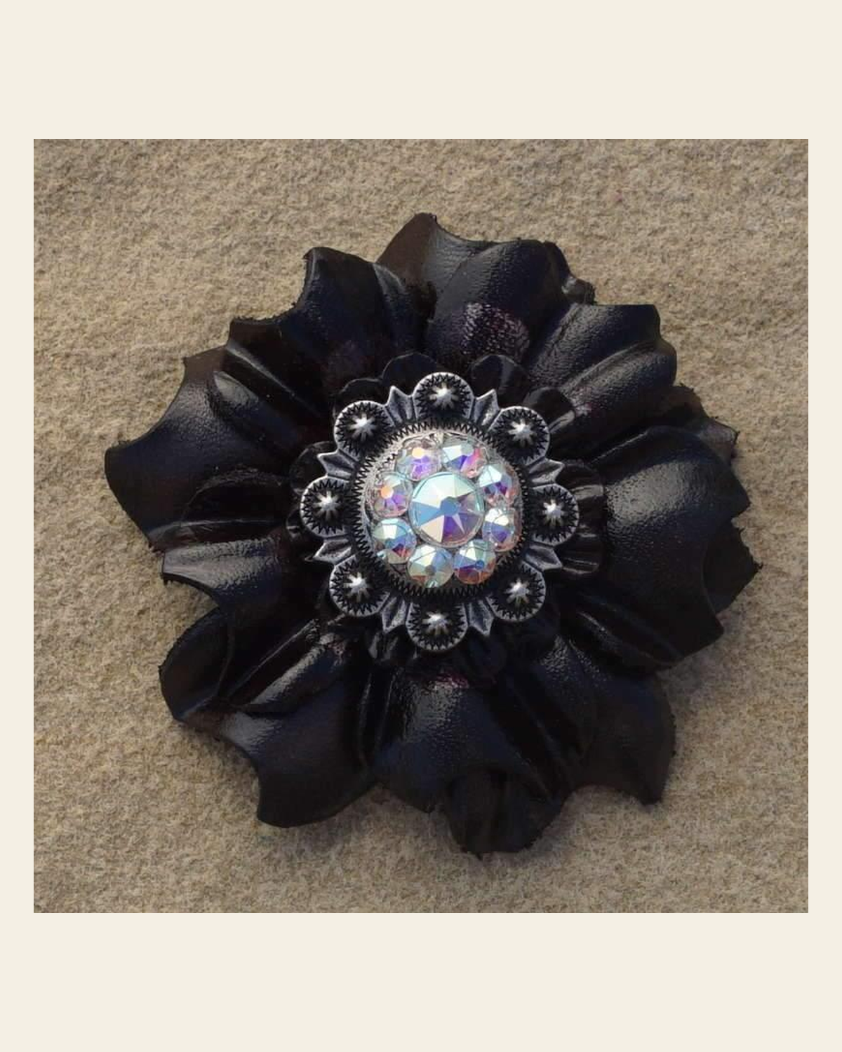 Black Carnation Flower With Antique Silver AB 1" Concho on a warm cream background