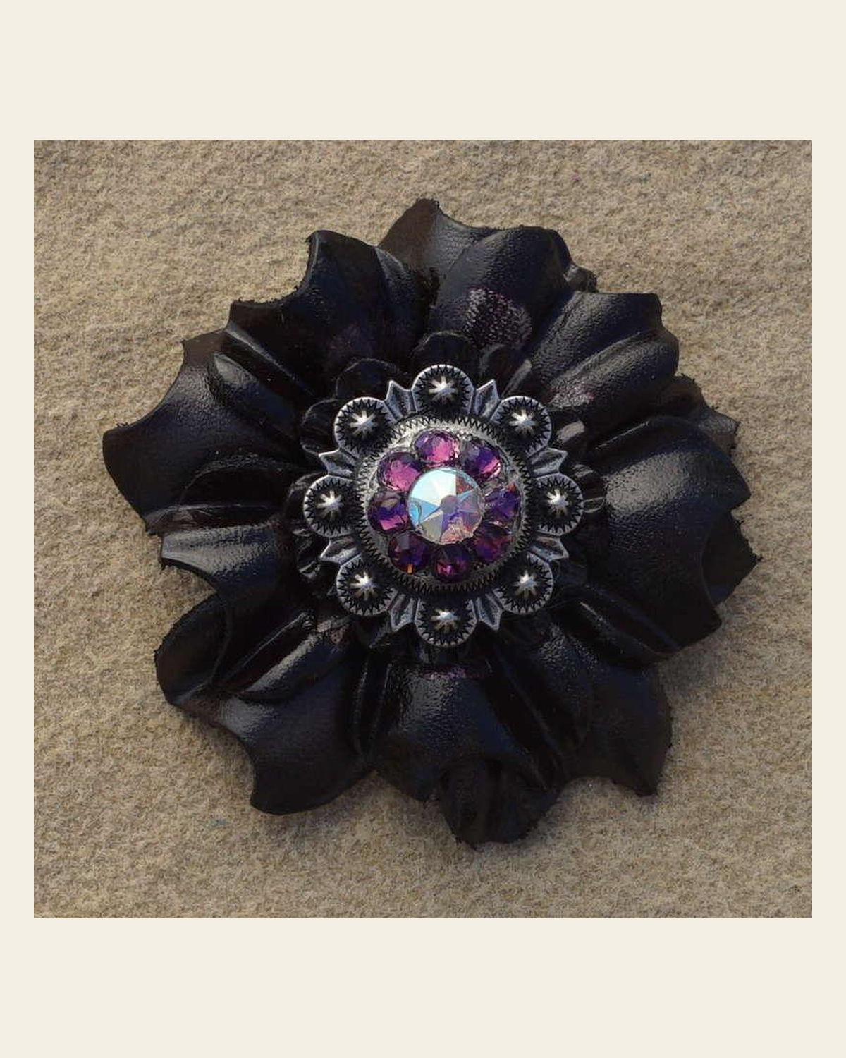 Black Carnation Flower With Antique Silver Amethyst and AB 1" Concho on a warm cream background