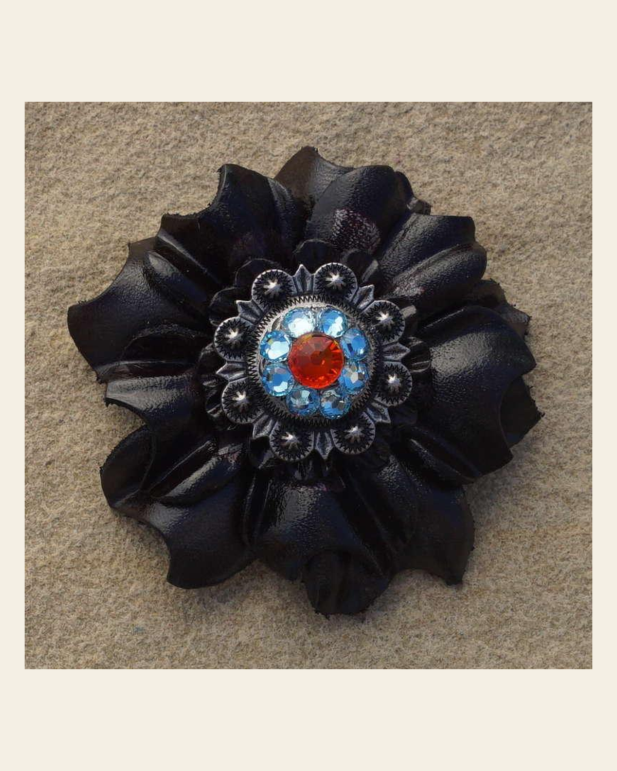 Black Carnation Flower With Antique Silver Fire Opal and Aqua 1" Concho on a warm cream background