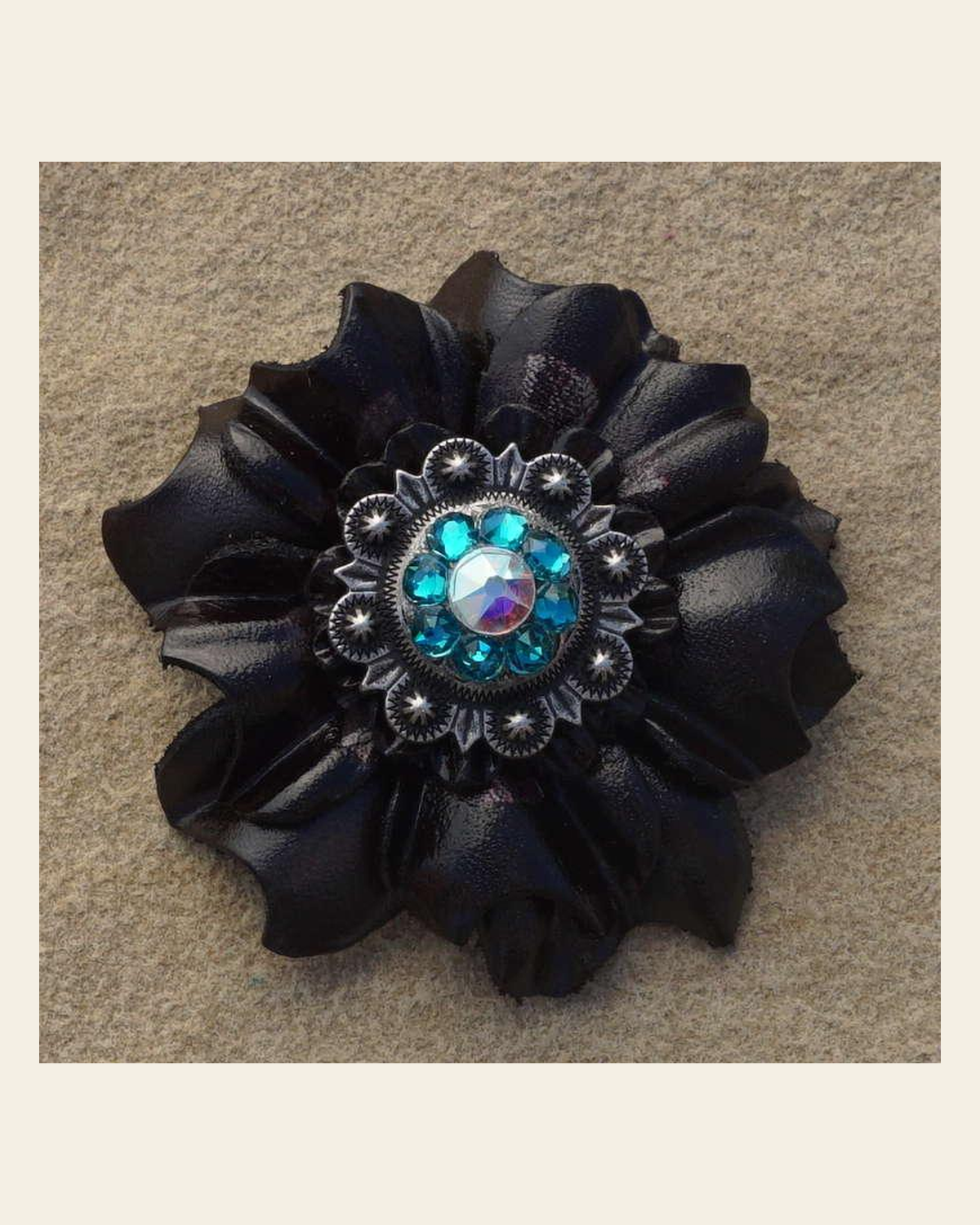 Black Carnation Flower With Antique Silver Teal and AB 1" Concho on a warm cream background