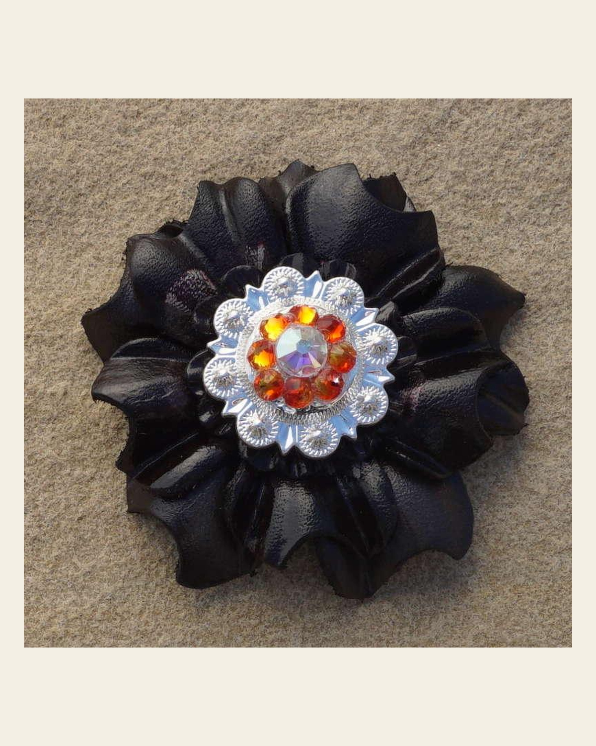 Black Carnation Flower With Bright Silver Fire Opal and AB 1" Concho on a warm cream background