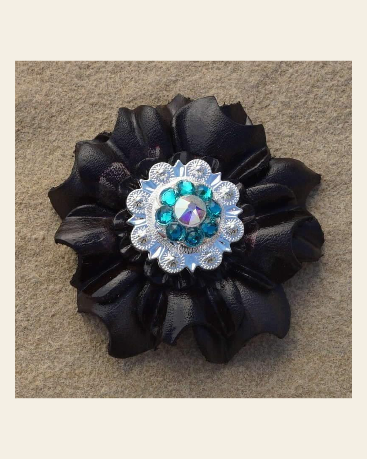 Black Carnation Flower With Bright Silver Teal & AB 1" Concho on a warm cream background