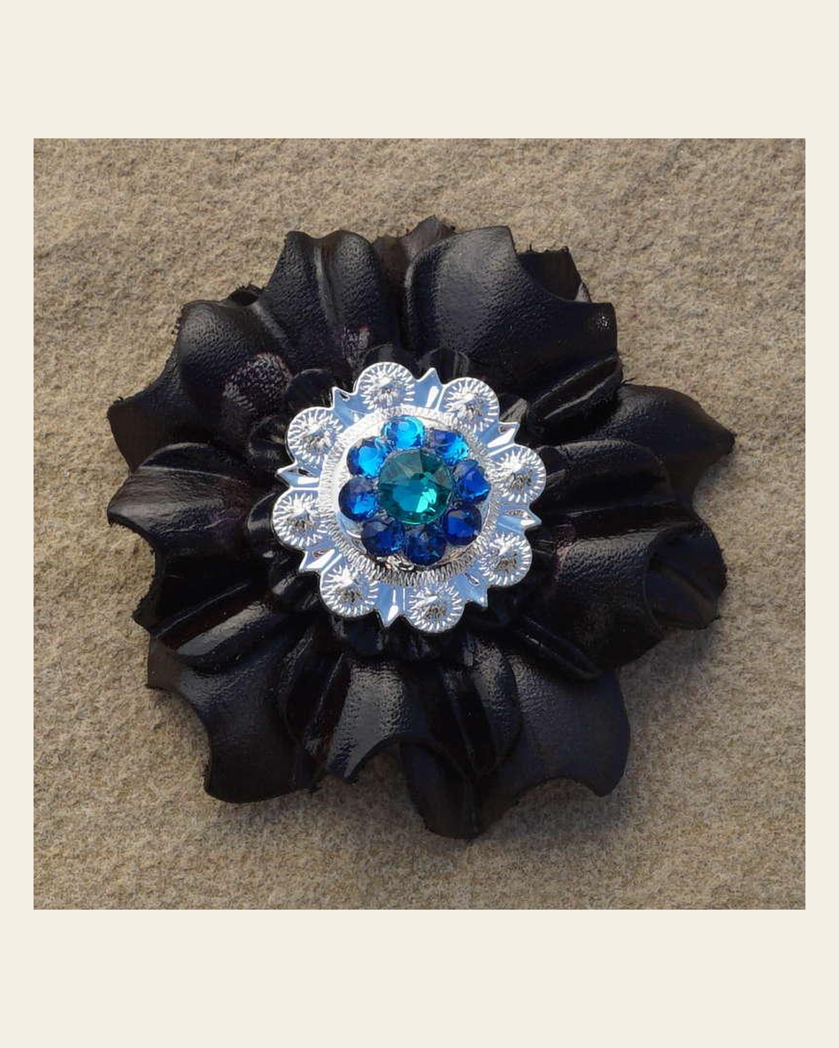 Black Carnation Flower With Bright Silver Teal and Capri 1" Concho on a warm cream background