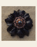 Black Carnation Flower With Copper Jet & Topaz 1" Concho on a warm cream background