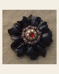 Black Carnation Flower With Copper Ruby and Champagne 1" Concho on a warm cream background