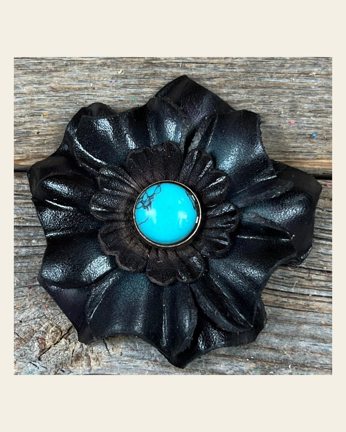 Black Carnation Flower With Round Turquoise Cabochon on a warm cream background