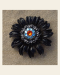 Black Daisy Flower With Antique Silver Fire Opal and Aqua 1" Concho on a warm cream background