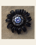 Black Daisy Flower With Antique Silver Lilac and Light Sapphire 1" Concho on a warm cream background