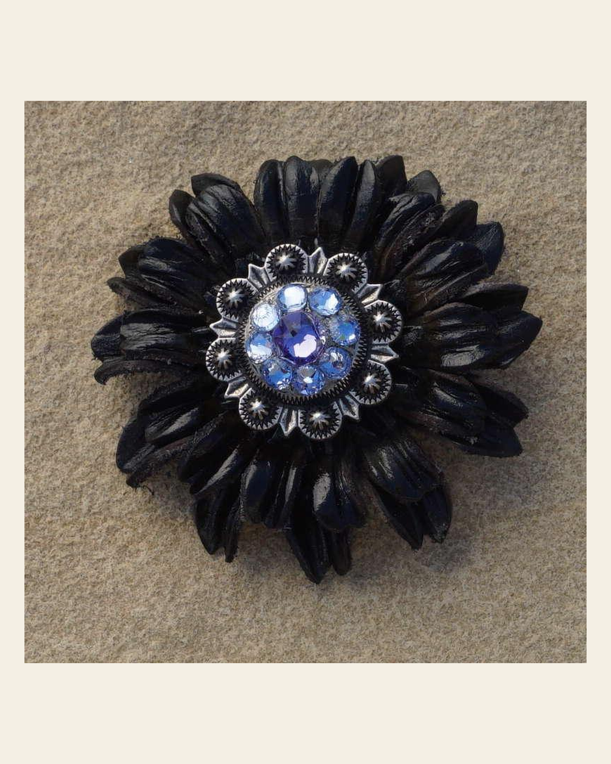 Black Daisy Flower With Antique Silver Lilac and Light Sapphire 1" Concho on a warm cream background