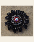 Black Daisy Flower With Antique Silver Ruby and AB 1" Concho on a warm cream background