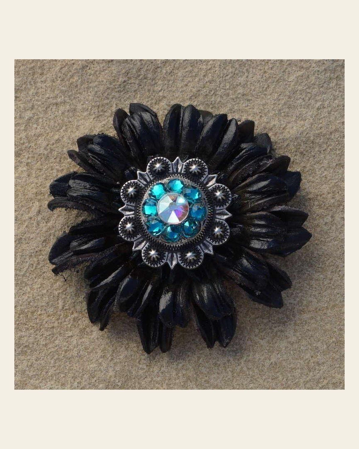 Black Daisy Flower With Antique Silver Teal and AB 1" Concho on a warm cream background