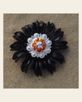Black Daisy Flower With Bright Silver Fire Opal and AB 1" Concho on a warm cream background