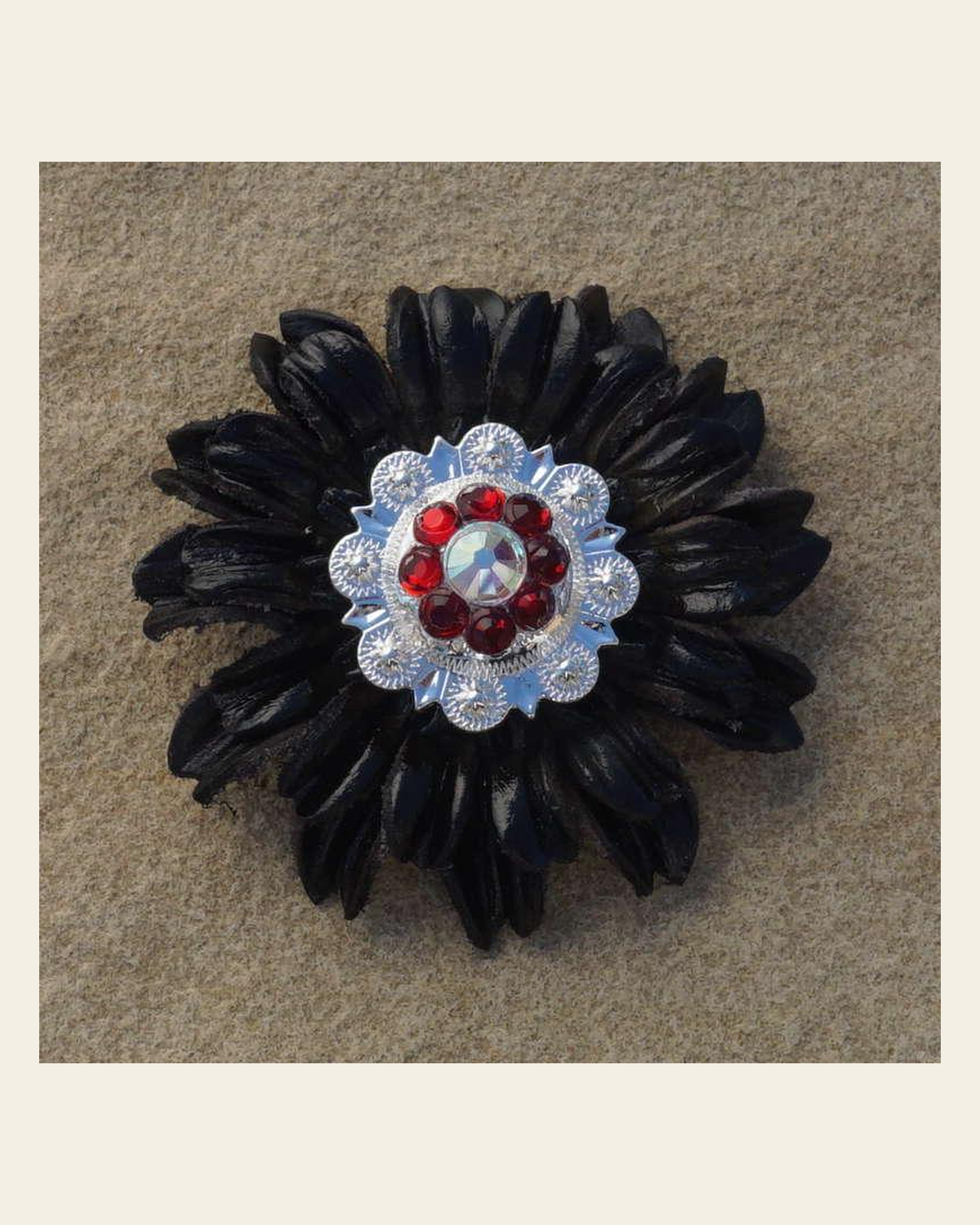 Black Daisy Flower With Bright Silver Ruby and AB 1" Concho on a warm cream background