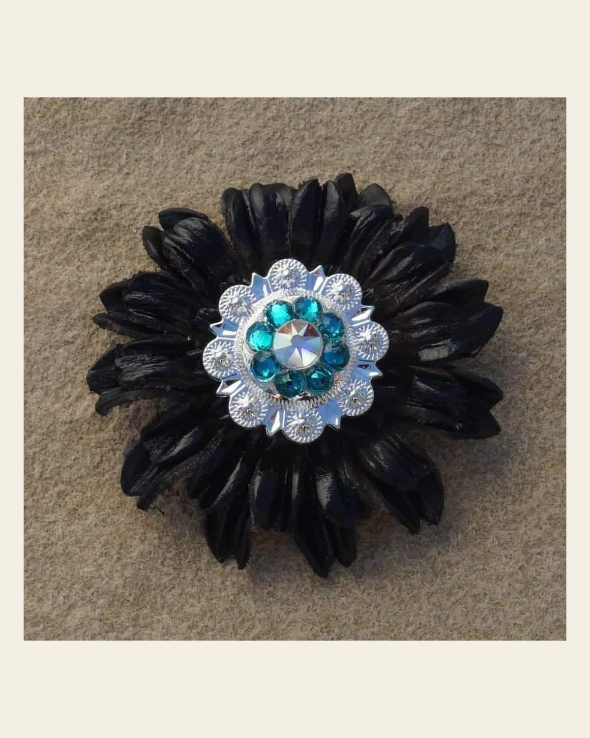 Black Daisy Flower With Bright Silver Teal & AB 1" Concho on a warm cream background