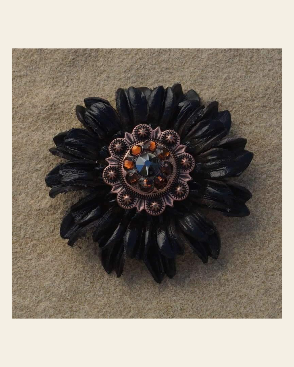 Black Daisy Flower With Copper Jet & Topaz 1" Concho on a warm cream background