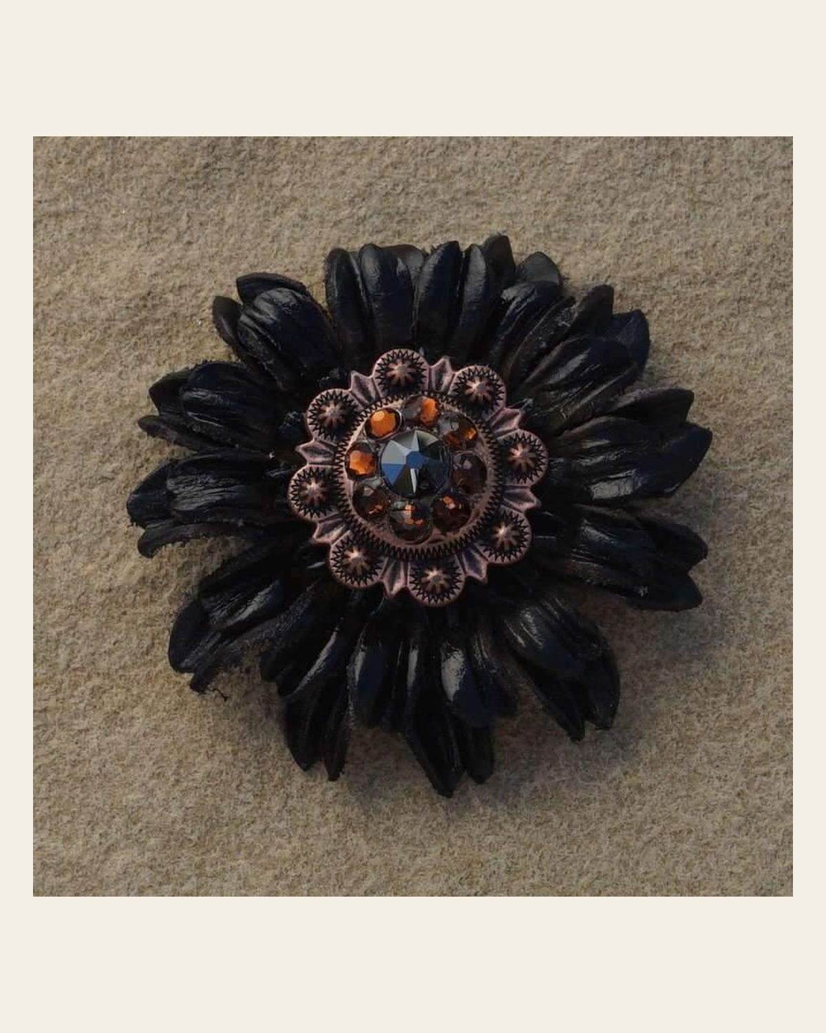 Black Daisy Flower With Copper Jet & Topaz 1" Concho on a warm cream background