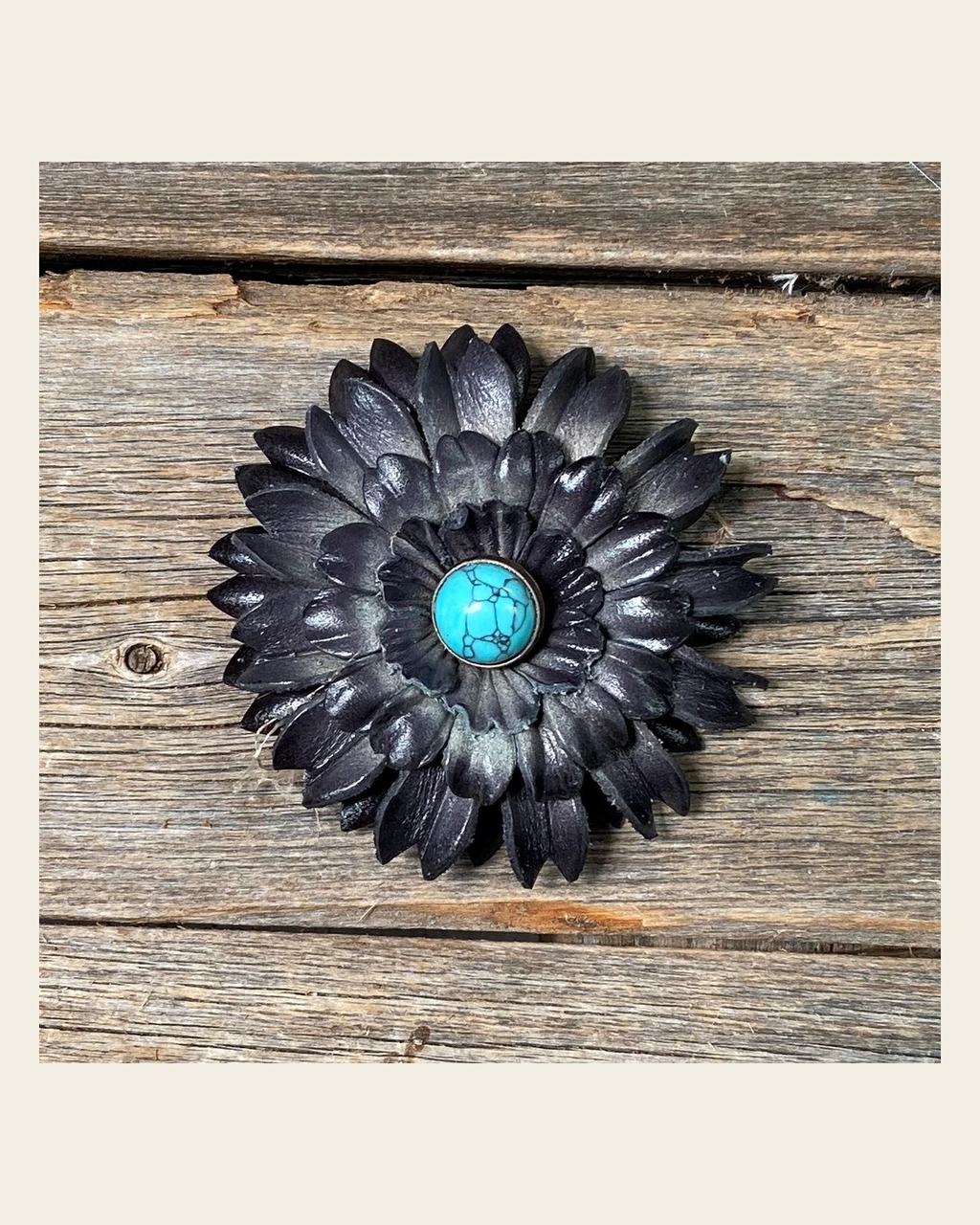 Black Daisy Flower With Round Turquoise Cabochon on a warm cream background