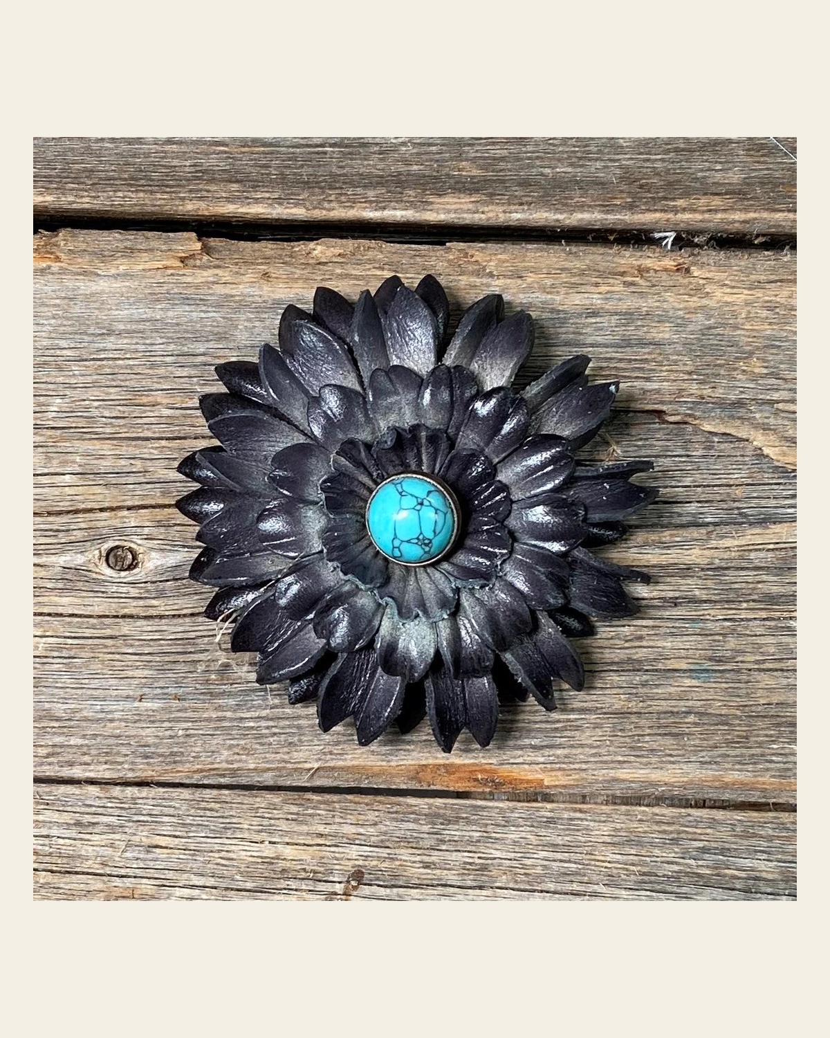 Black Daisy Flower With Round Turquoise Cabochon on a warm cream background