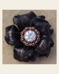 Black Gardenia Flower With Copper Clear 1" Concho on a warm cream background