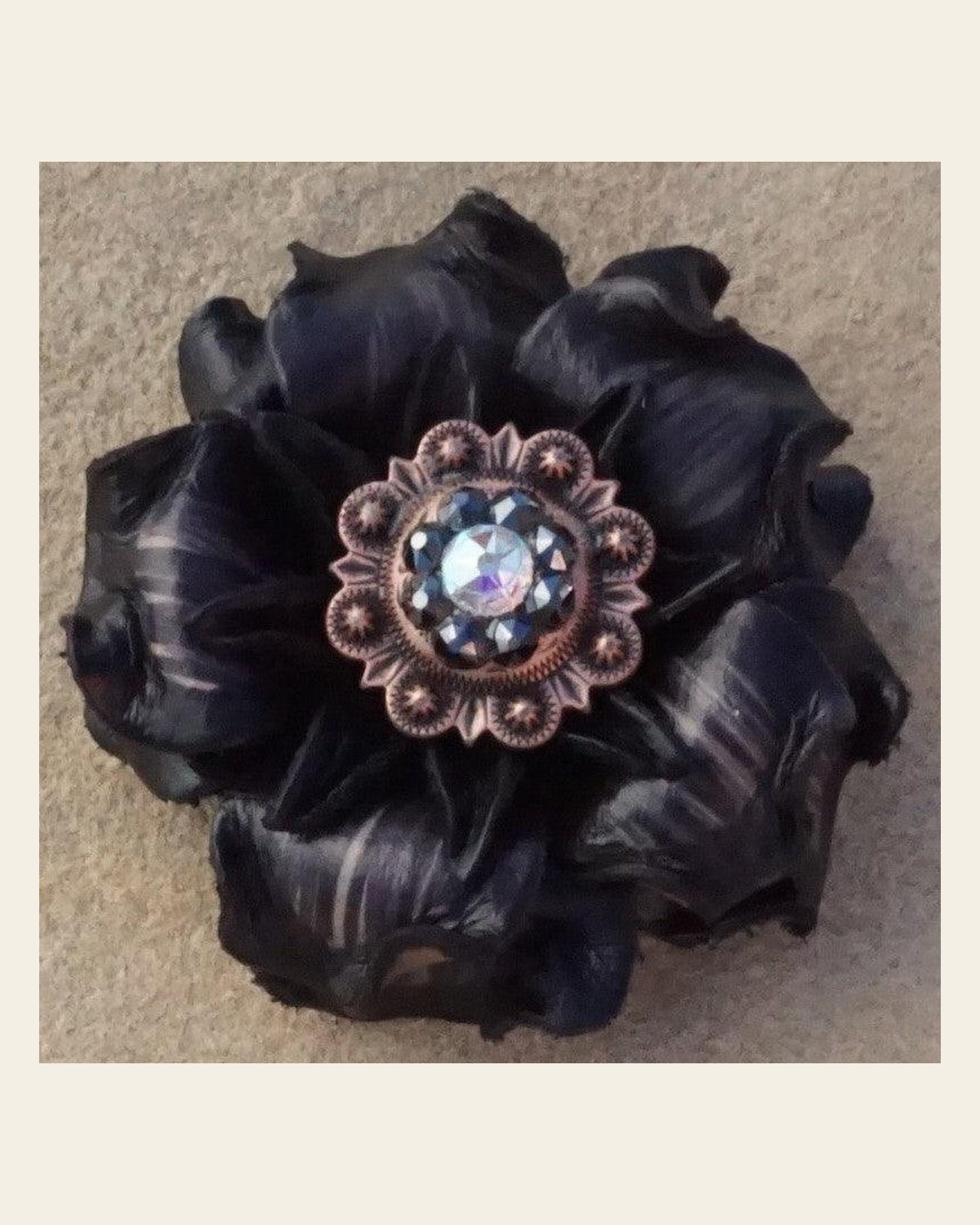 Black Gardenia Flower With Copper Jet & AB 1" Concho on a warm cream background