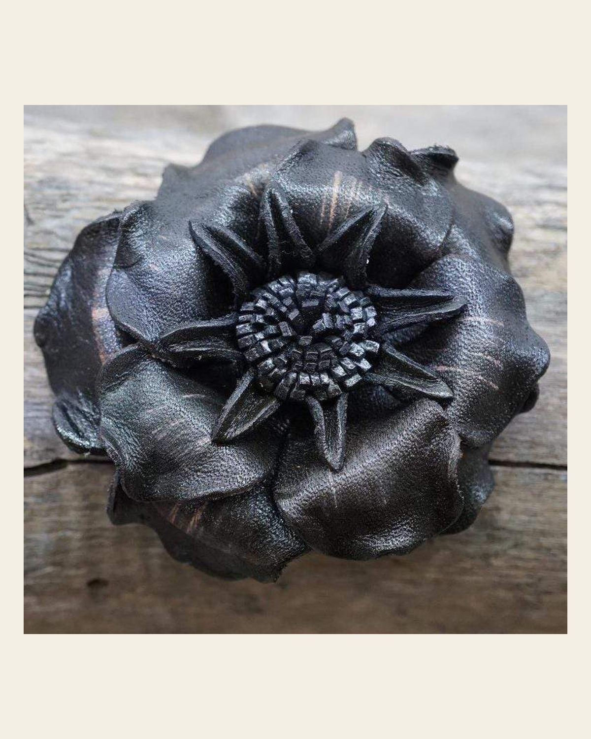 Black Gardenia Leather Flower on a warm cream background