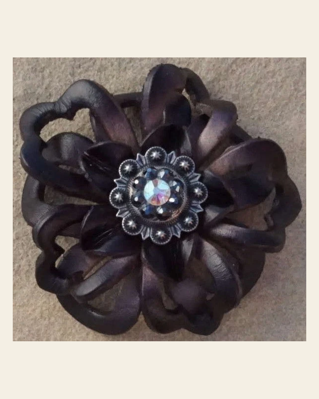 Black Lotus Flower With Antique Silver Jet and AB 1" Concho on a warm cream background