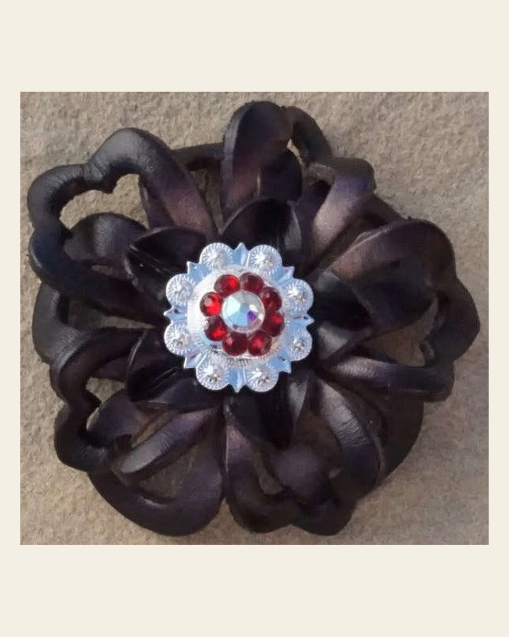 Black Lotus Flower With Bright Silver Ruby and AB 1" Concho on a warm cream background
