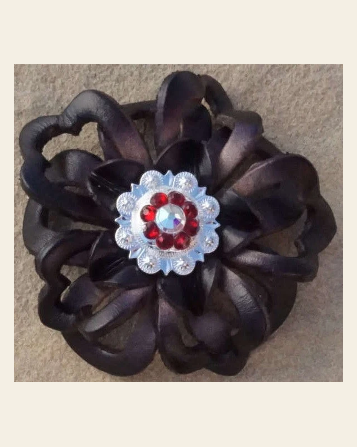 Black Lotus Flower With Bright Silver Ruby and AB 1" Concho on a warm cream background