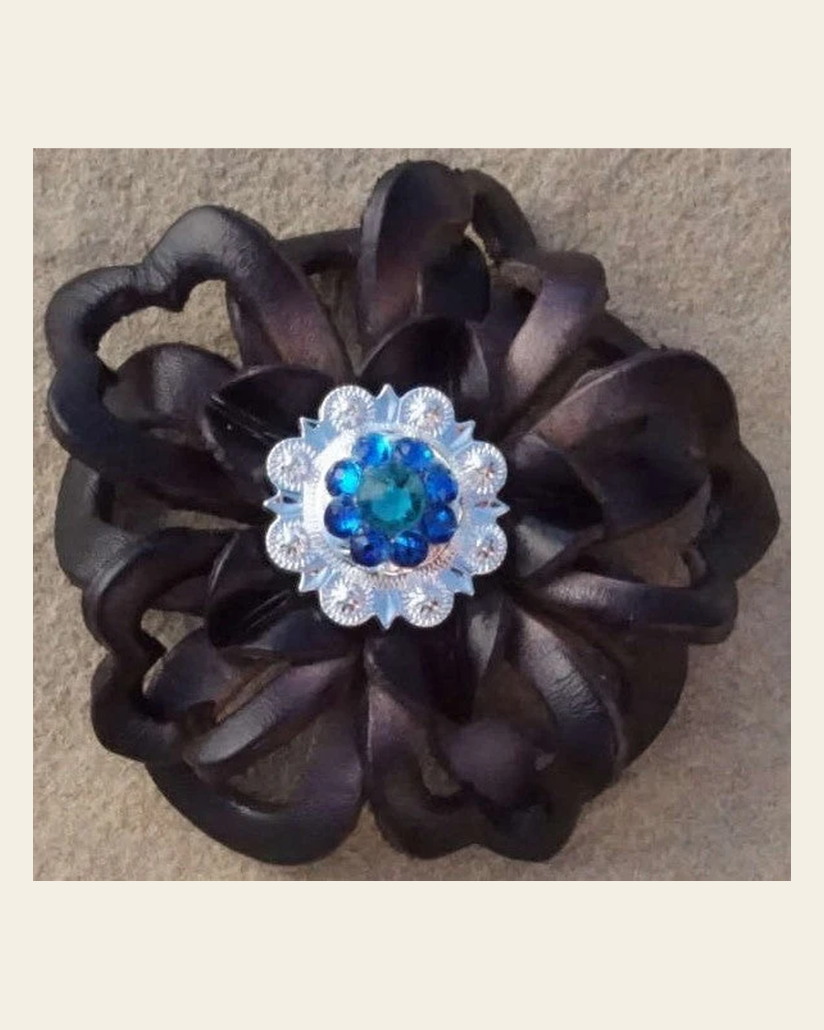 Black Lotus Flower With Bright Silver Teal and Capri 1" Concho on a warm cream background