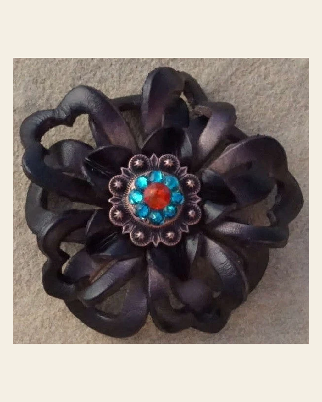 Black Lotus Flower With Copper Fire Opal and Teal 1" Concho on a warm cream background