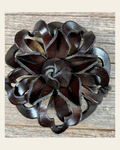 Black Lotus Leather Flower on a warm cream background
