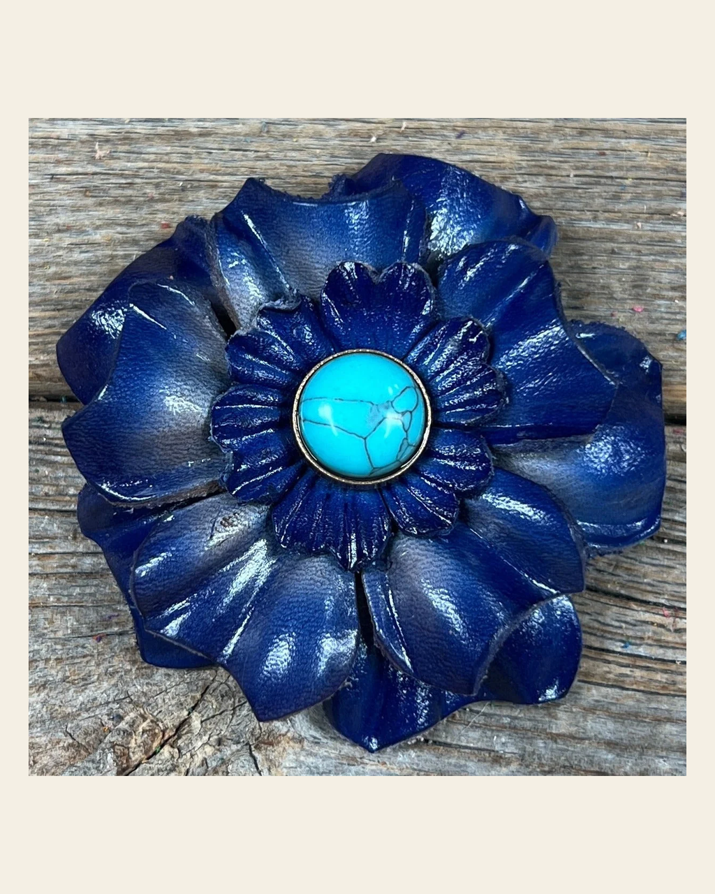Blue Carnation Flower With Round Turquoise Cabochon on a warm cream background