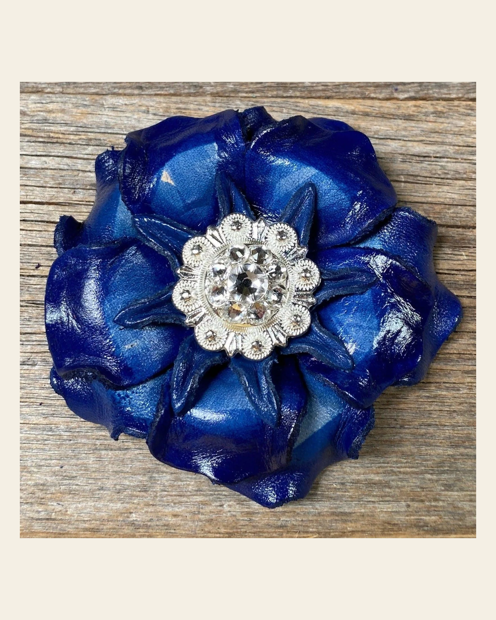 Blue Gardenia Flower With Bright Silver Clear 1" Concho on a warm cream background