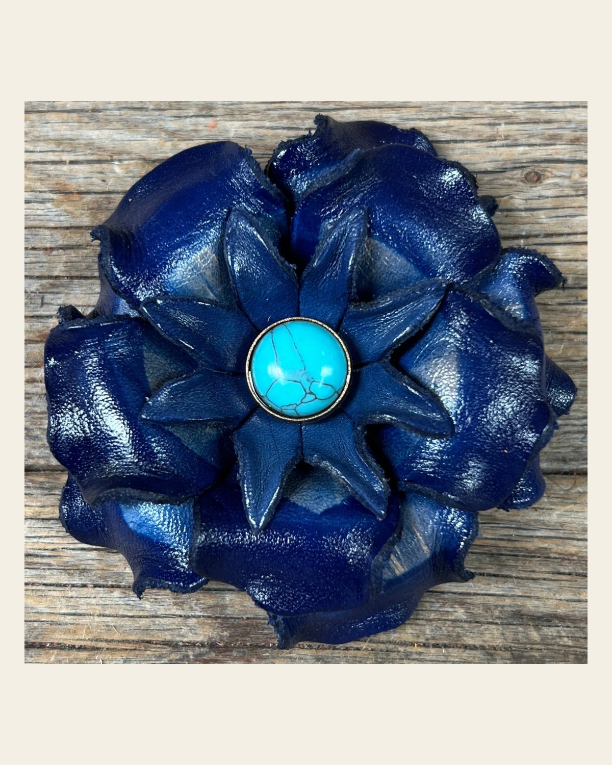 Blue Gardenia Flower With Round Turquoise Cabochon on a warm cream background