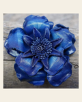 Blue Gardenia Leather Flower on a warm cream background