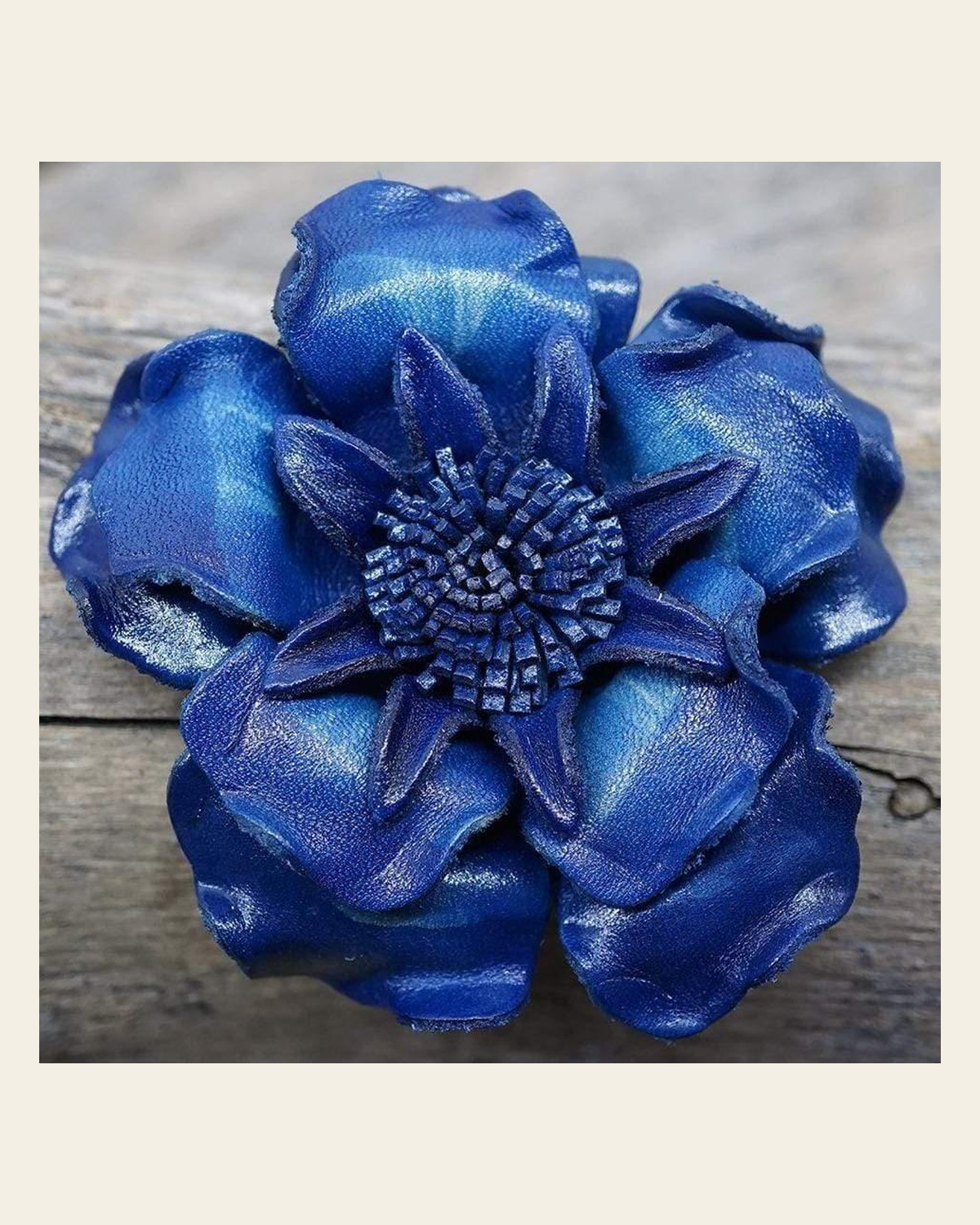 Blue Gardenia Leather Flower on a warm cream background