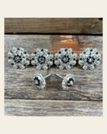 Bright Silver Black & Clear Saddle Conchos on a warm cream background