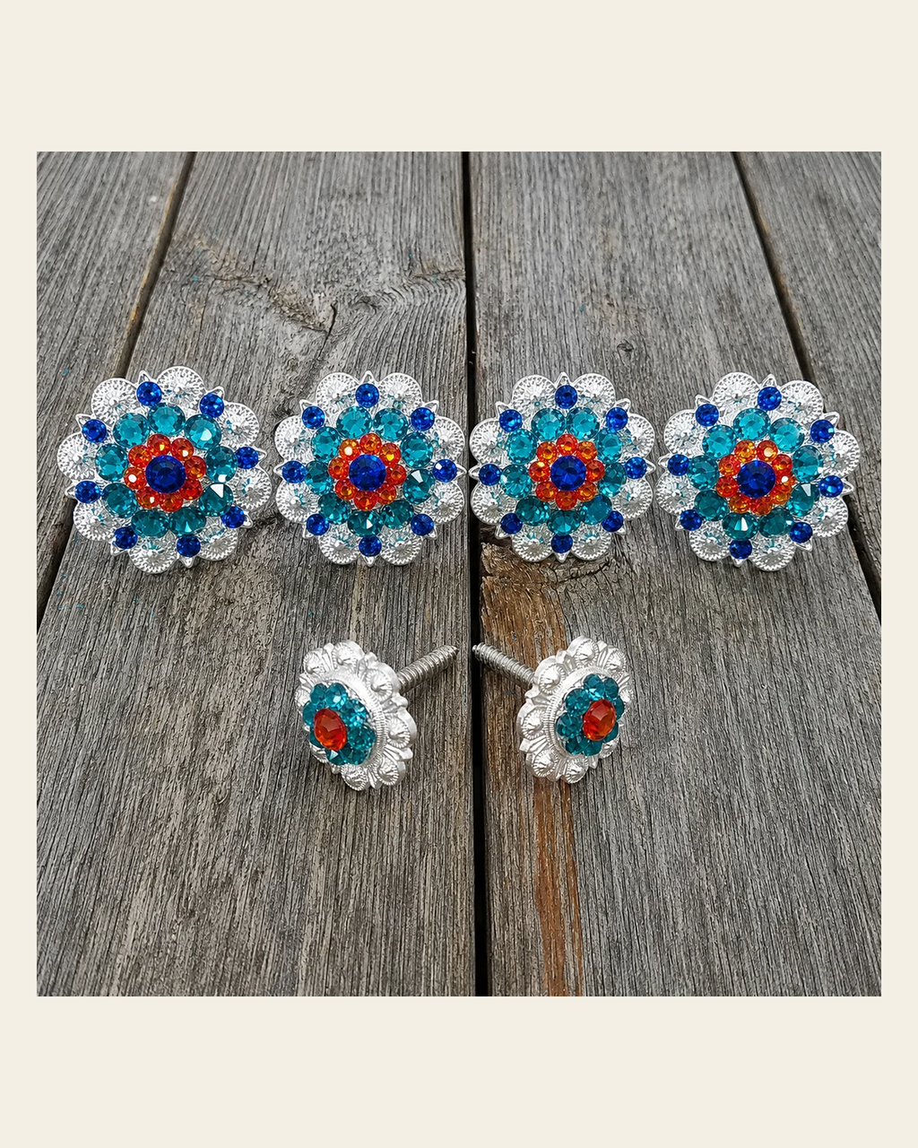 Bright Silver Capri Fire Opal & Teal Saddle Conchos on a warm cream background