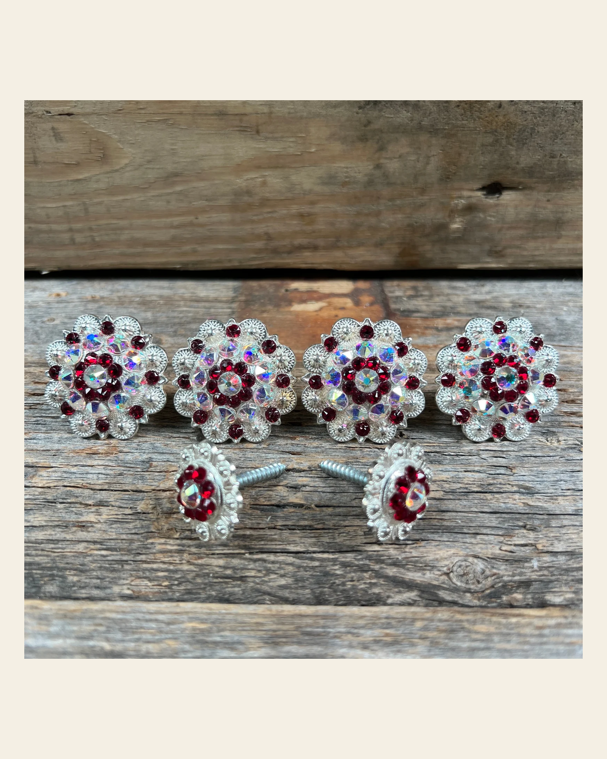 Bright Silver Ruby & AB Saddle Conchos on a warm cream background