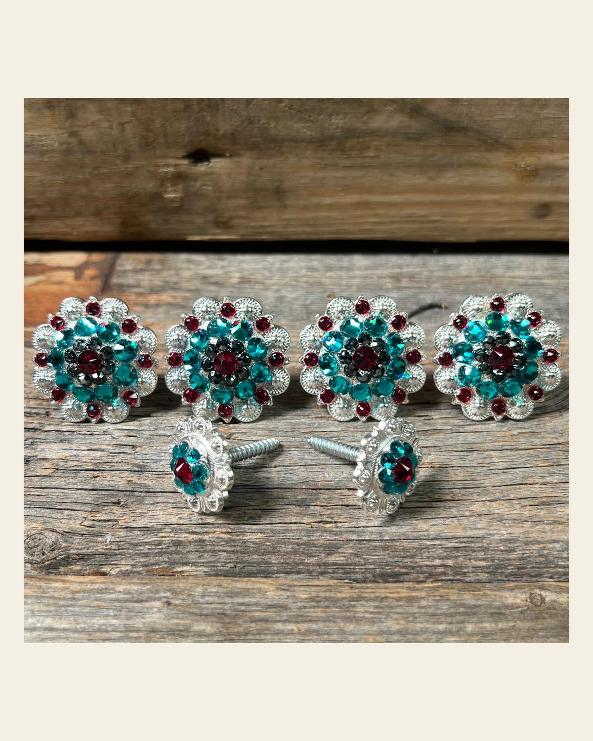 Bright Silver Ruby Jet & Teal Saddle Conchos on a warm cream background