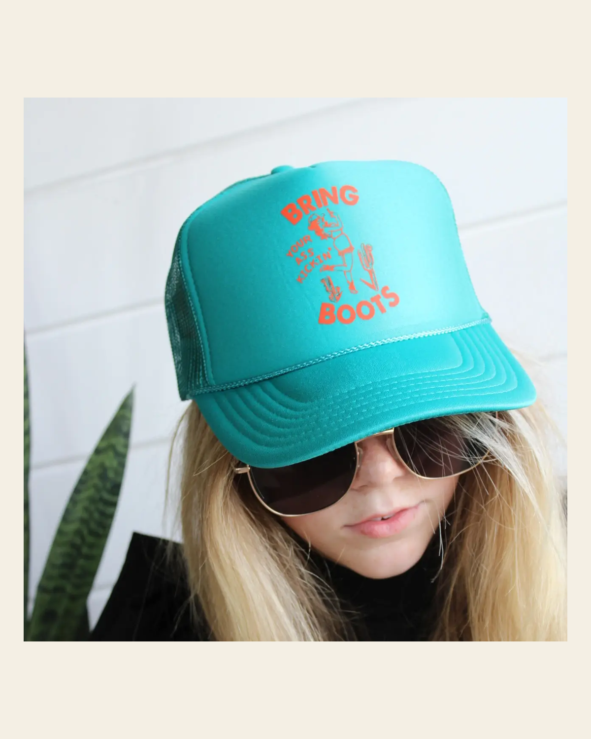 Bring Your Ass Kickin' Boots Trucker | Cap on a warm cream background