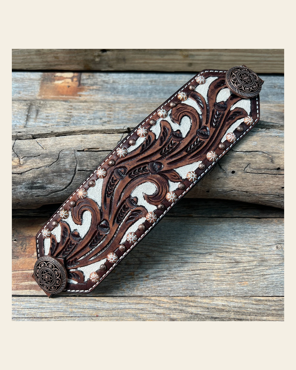 Bronc Noseband With Copper Intricate Engraved Western Conchos on a warm cream background