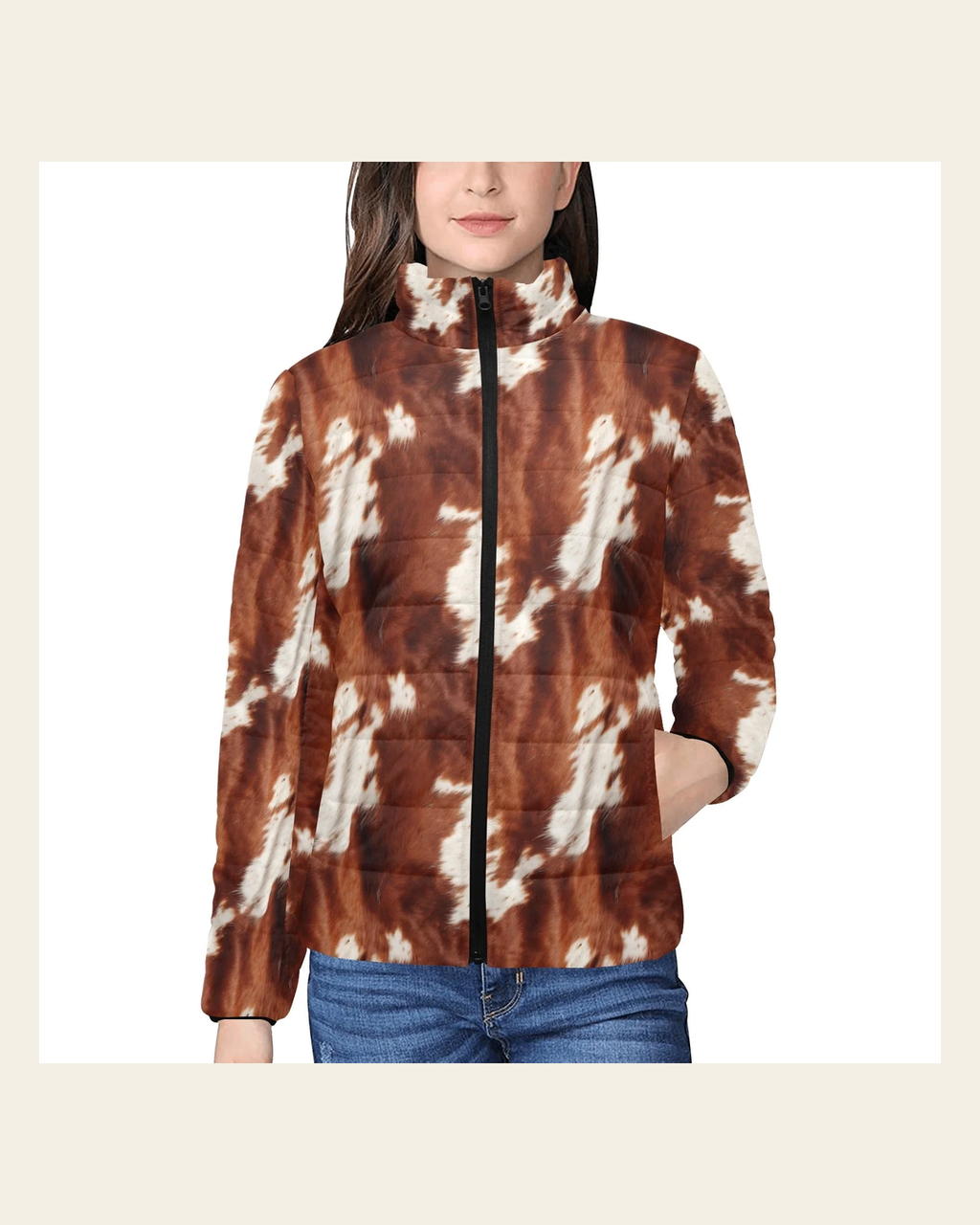 Brown Cow Print Women's Puffy Bomber Jacket on a warm cream background