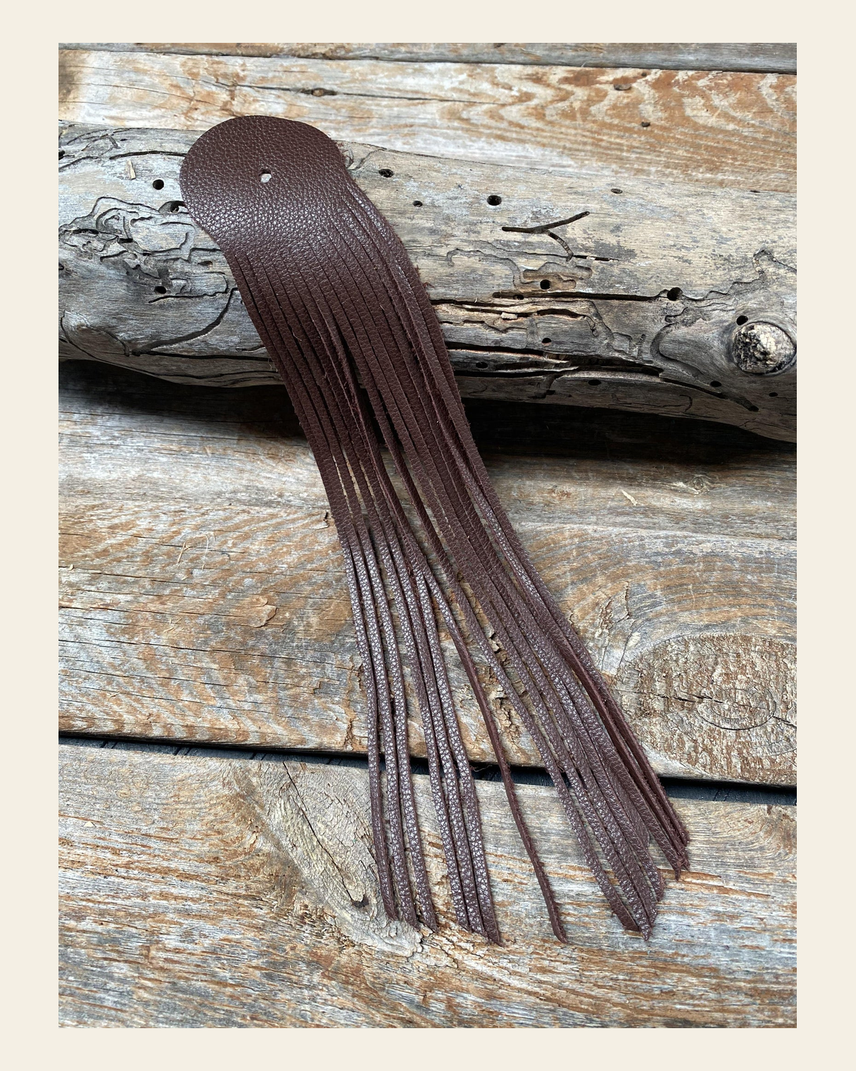 Brown Leather Fringe on a warm cream background