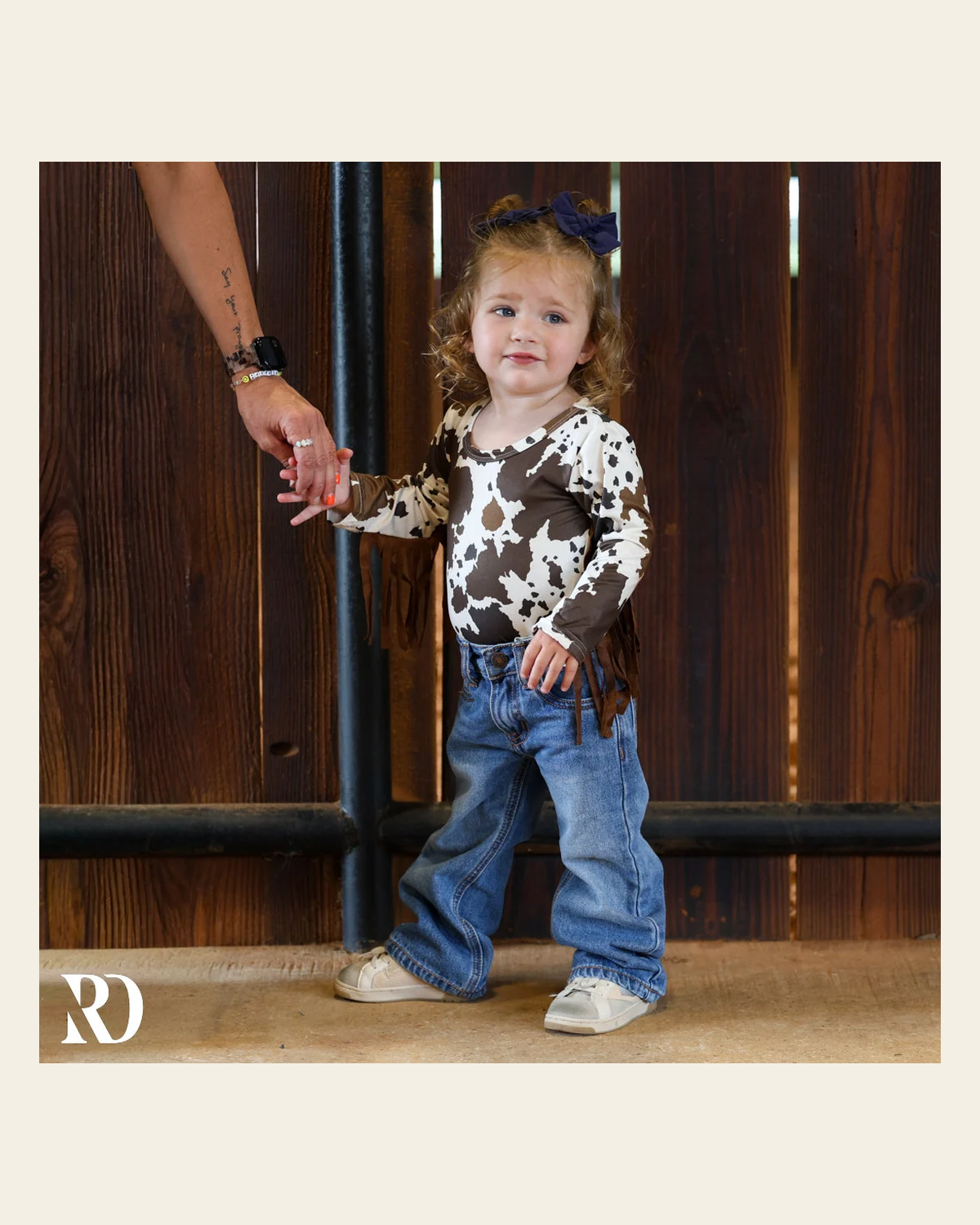 Cattle Drive Fringe Infant / Toddler Bodysuit on a warm cream background