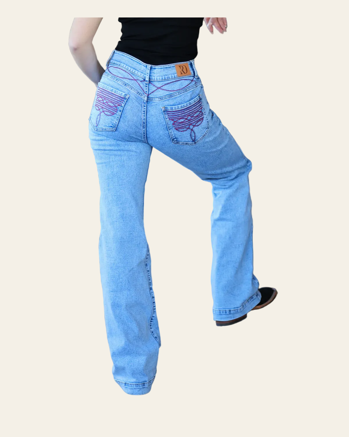 Cheyenne Trousers - Acid Wash Red Pocket on a warm cream background